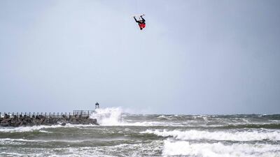 A competitor turns upside down during the Big Air kitesurfing contest in the North Sea near Vorupoer in Denmark, on Thuursday, September 23. AFP