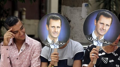 Syrians living in Egypt hold portraits of President Assad as they gather to support the Syrian presidential elections outside the Syrian Consulate in Cairo, Egypt. Amel Pain / EPA