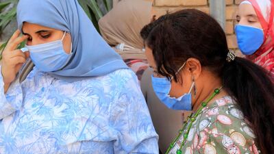 Egyptian women wearing protective face masks wait to ride a bus in Cairo, Egypt. Reuters