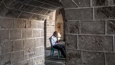 A Palestinian reads from the Quran at Al-Omari mosque in Gaza City. EPA