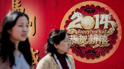 Two women walk past decorations in Hong Kong on the eve of the Lunar New Year. Over a billion Chinese in China and millions more all over the world will be celebrating the Lunar New Year. Philippe Lopez / AFP Photo