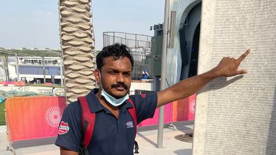 Jayakrishnan Mullasseerich from Kerala points to his name on the workers monument at Expo 2020. He worked on the project for two years