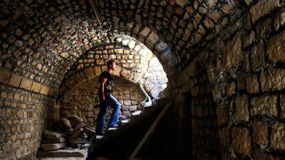 A Free Syrian Army fighter climbs the stairs while carrying his weapon in the Bab al-Nasr neighborhood of Aleppo, Syria. Hamid Khatib / Reuters