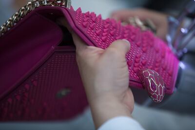 The enamelled serpent clasp comes in a two-tone palette