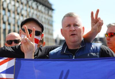 Paul Goulding (R), leader of the far-right political group Britain First stands by the statue of Winston Churchill. EPA