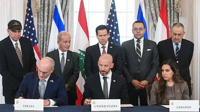 Israel's ambassador to the US Yechiel Leiter, US State Department counsellor Daniel Holler and Lebanese ambassador to the US Nada Hamadeh sign the framework agreement in Washington. AFP