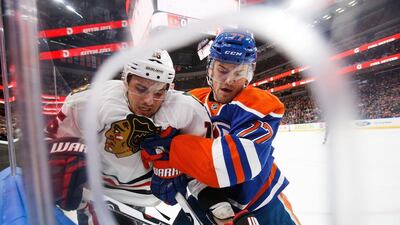 Oscar Klefbom of the Edmonton Oilers battles along the boards with Artem Anisimov of the Chicago Blackhawks on November 21, 2016 at Rogers Place in Edmonton, Alberta, Canada. Codie McLachlan / AFP