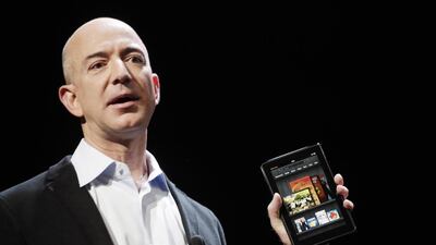 Amazon chief executive Jeff Bezos with the Amazon Kindle. Mark Lennihan/AP Photo