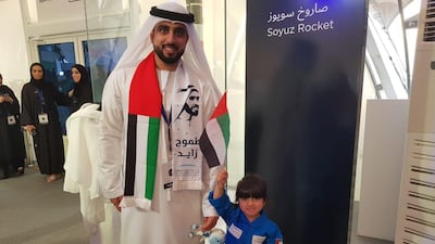 Hamad Al Blooshi, an engineer at Mohammed bin Rashid Space Centre, brings his daughter Maryam, 3, to watch the live stream of the launch, at MBRC in Dubai. Patrick Ryan / The National