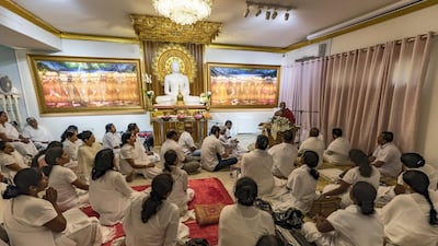 Worshippers hear the sermon at Dubai's Buddhist temple. Chris Whiteoak / The National