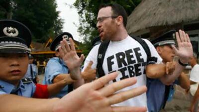 Security guards drag away a protester wearing a t-shirt with a "Free Tibet" slogan in Beijing last week. Security forces dragged away US pro-Tibetan protesters who chained their bicycles to the gate of a northern Beijing park, on the sidelines of the 2008 Olympics.