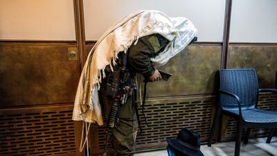 An ultra-Orthodox Jewish member of the Israeli military prays, a day after the country debated a draft exemption bill for the group. Reuters