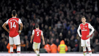 Mesut Ozil looks glum after Arsenal conceded during the Premier League match against Wolves. Getty