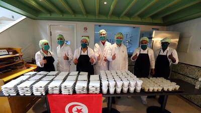 Tunisian cooks pose for a photo after preparing meals for the underprivileged at the Dar Slah restaurant in the medina of Tunis, Tunisia. EPA