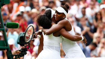 Serena Williams, left, hugs Venus Williams after their Ladies' Singles fourth round match during Day 7 of the Wimbledon Lawn Tennis Championships at the All England Lawn Tennis and Croquet Club on July 6, 2015, in London, England. Julian Finney / Getty Images