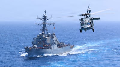 The USS Donald Cook transits the Arabian Sea accompanied by an MH-60S Sea Hawk as American forces enforce a naval blockade against Iran. Photo: Centcom