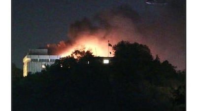 Smoke rises from the Intercontinental hotel, Kabul, yesterday as a Nato helicopter flies overhead. Omar Sobhani / Reuters