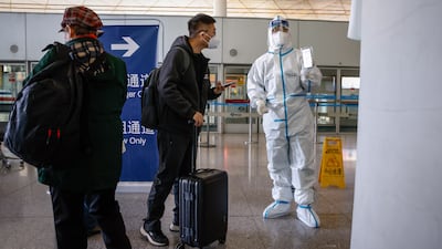 Passengers present their health information before departure at the Beijing Capital International Airport on November 30. The airport has since dropped its Covid rules. EPA
