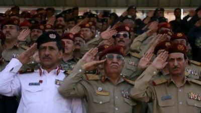 Yemeni army officers salute at the end of a sombre military parade marking the 22nd anniversary of Yemen's 1990 reunification in Sanaa today.