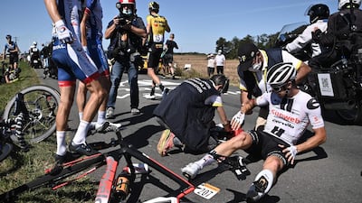 Nicolas Roche is helped by medics after crashing. AFP
