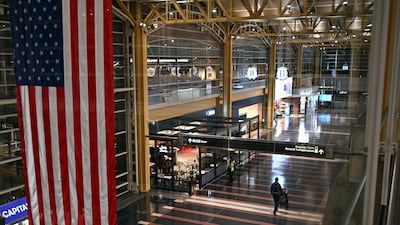 A single passenger walks through the checking area of Ronald Reagan Washington National Airport. AFP