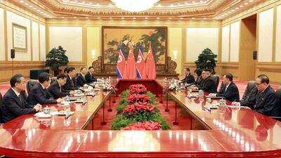 The North Korean delegation and Chinese officials hold a meeting in Beijing. KCNA / EPA