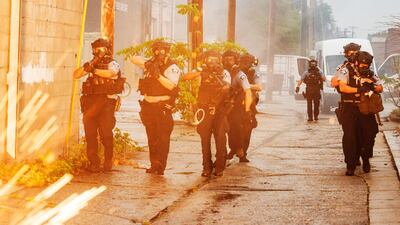 Police officers deploy to disperse protesters gathered for George Floyd in Minneapolis. AP