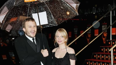 Michelle Williams, in an off-the-shoulder black dress, and Heath Ledger arrive at the British Academy Film Awards in London, England on February 19, 2006. Getty Images
