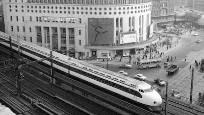 A Shinkansen train passes by Nichigeki Theater in the Yurakucho district shortly after leaving Tokyo Station in 1964. AP Photo