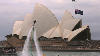 An Australian flag flies underneath a military helicopter past the Sydney Opera House to mark Australia Day. Steven Saphore / Reuters