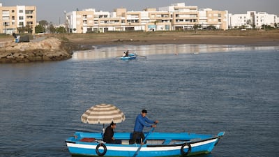 Small blue wooden boats have been transporting people between the banks of Bou Regreg river in Morocco for generations. All photos: Reuters