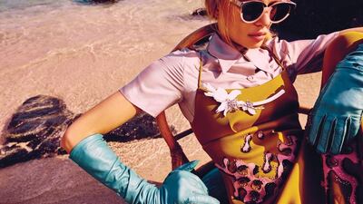 SEASIDE GAZE: Shirt, Dress, Gloves, all price on request, Prada; Brooch, Dh2,815, Prada; Shoes, Dh1,850, Tods; Sunglasses, Dh945, Preen by Thorton Bregazzi at Boutique 1; Socks, stylists own.