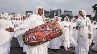 Ethiopian Orthodox choir members play leather drums, known as kebero, while singing hymns during annual religious celebrations in Addis Ababa. AFP