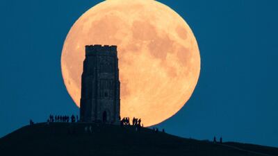The supermoon rises behind Glastonbury Tor in Somerset, England. Matt Cardy / Getty Images