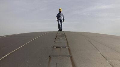 An employee walks on top of an oil tank at a Sinopec refinery in Wuhan, Hubei province. China's two big oil firms are on a roll.. Reuters