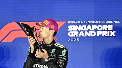 Mercedes driver George Russell celebrates on the podium after winning the Singapore Grand Prix. AFP