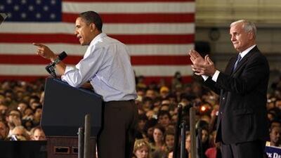 U.S. President Barack Obama receives applause from gubernatorial candidate Mark Dayton (R) during a campaign rally in Minneapolis, Minnesota.