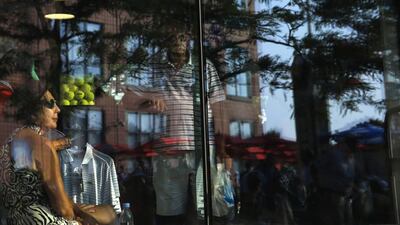 A woman watches a match inside a merchandise store at the 2014 US Open tennis tournament in New York. Shannon Stapleton / Reuters / August 26, 2014