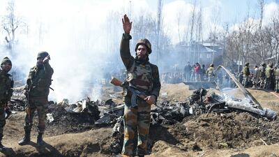 Indian soldiers gesture near the remains of an Indian Air Force aircraft after it crashed in Budgam district, 30km from Srinagar. AFP