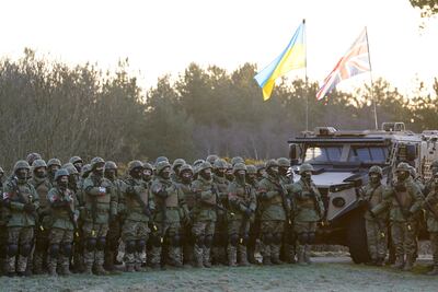 Ukrainian troops and their UK military instructors commemorate lives lost in the Russian invasion. PA