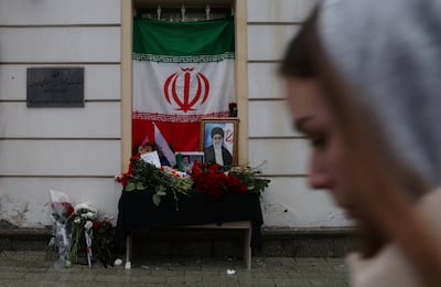 A portrait of late Iranian supreme leader Ayatollah Ali Khamenei stands among flowers outside the Iranian Embassy in Moscow. Reuters