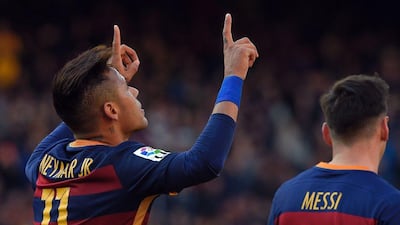 Barcelona’s Brazilian forward Neymar (L) celebrates after scoring during the Spanish league football match FC Barcelona vs Getafe CF at the Camp Nou stadium in Barcelona on March 12, 2016. AFP / LLUIS GENE