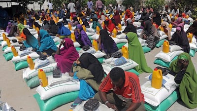 Somali internally displaced people (IDP) receive food aid donated by a Qatari charity during the holy Muslim month of Ramadan in Mogadishu, Somalia on June 20, 2015. Aid is distributed to the poor and needy in the month of Ramadan, where believers fast from sunrise to sunset. Mohamed Abdiwahab / AFP photo