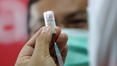 A health worker holds a vial of a Covid-19 vaccine at Banda Aceh General Hospital, in Banda Aceh, Indonesia. EPA