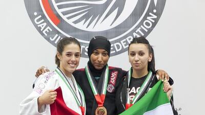 Emirati jiu-jitsu practioner Eman Mohammed, centre, took gold at the Abu Dhabi Jiu-Jitsu Cup and later discussed participating in her hijab, a point of contention with the International Brazilian Jiu-Jitsu Federation, who contend the head scarf may injure her while she is wrestling in it. Viktoryia Vinnikava / The National.