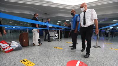 Passengers wait in line for check-in for their repatriation flight for Libya, at the Tunis Carthage International Airport in Tunis, Tunisia. EPA