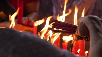 Pilgrims lighting incense sticks