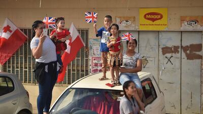 People cheer for Britain's Prince Harry and his wife Meghan, Duchess of Sussex as their convoy from Fua'amotu airport in Tonga passes by. Prince Harry and his pregnant wife Meghan left Fiji after a three-day official visit and arrived in Tonga as part of their tour of Australia and the South Pacific. AFP