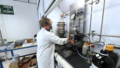 A researcher works on newly developed tar for smart roads at the Eurovia research centre. Medhi Fedouach/AFP