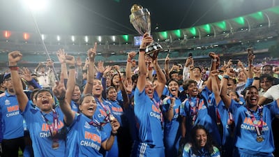 India's Harmanpreet Kaur and teammates celebrate with the trophy after winning the ICC Women's World Cup. Reuters